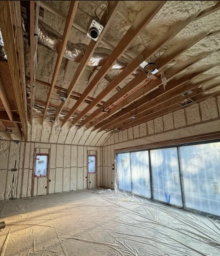 Interior walls and ceiling insulated with spray foam during new construction in Holliston